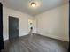A clean, empty bedroom shows off updated flooring and a doorway leading to another room at 1622 S Randolph St, Indianapolis, IN 46203