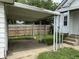 The property features a convenient carport leading to the backyard, enhanced by decorative metal supports at 1622 S Randolph St, Indianapolis, IN 46203