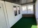 Bright sunroom featuring large windows, white walls, and a cozy green carpet at 1622 S Randolph St, Indianapolis, IN 46203