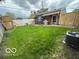Backyard with playset, lush grass, and outdoor cooking area at 1623 Oliver Ave, Indianapolis, IN 46221
