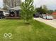 Well maintained front yard of this cute home with deck and long driveway at 1623 Oliver Ave, Indianapolis, IN 46221