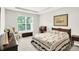 Bright bedroom featuring a large window, dresser, and a patterned bedspread at 16693 Churning Way, Noblesville, IN 46060