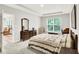 Calm bedroom showcasing a dresser, large window, and patterned bedspread at 16693 Churning Way, Noblesville, IN 46060