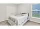 Bright bedroom with carpeted floors, window, double closet with white doors and classic quilt at 16693 Churning Way, Noblesville, IN 46060