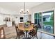 Open-concept dining room leading to a living space and outdoor patio at 16693 Churning Way, Noblesville, IN 46060