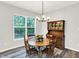 Charming dining room with wooden table set and hutch next to a bright window at 16693 Churning Way, Noblesville, IN 46060