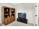 Cozy living room with classic bookshelf, TV, and doorway to another room at 16693 Churning Way, Noblesville, IN 46060