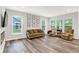 Bright and airy living room with a large sofa, comfortable seating, and large windows showcasing views at 16693 Churning Way, Noblesville, IN 46060
