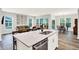 Open concept living space featuring a quartz island, seating, a living room, a dining area, and stylish flooring at 16693 Churning Way, Noblesville, IN 46060