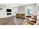 Bright living room featuring hardwood floors, modern fireplace, and large windows at 16693 Churning Way, Noblesville, IN 46060