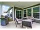 Outdoor covered patio with grill, comfortable seating, and view of the backyard at 16693 Churning Way, Noblesville, IN 46060