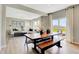 Open-concept dining area with modern table, bench seating, and ample natural light from sliding glass doors at 1713 Hemlock Cir, Greenfield, IN 46140
