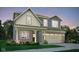 Charming two-story home with a brick facade, covered porch, and attached two-car garage at 1713 Hemlock Cir, Greenfield, IN 46140