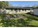 Grassy backyard featuring a fire pit and detached garage, ideal for outdoor gatherings and relaxation at 1716 Arlene Dr, Indianapolis, IN 46219