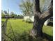 View of a grassy backyard with a chain link fence, including detached garage at 1716 Arlene Dr, Indianapolis, IN 46219
