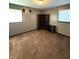 Neutral bedroom with soft carpet, two windows, and dark bookcase at 1716 Arlene Dr, Indianapolis, IN 46219