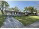 Charming single-story home featuring a well-maintained lawn, covered parking, and inviting curb appeal at 1716 Arlene Dr, Indianapolis, IN 46219