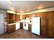 Functional kitchen features wood cabinetry, updated appliances, and durable tile flooring at 1716 Arlene Dr, Indianapolis, IN 46219