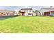 Large backyard features a two story home with a balcony, lush green lawn, and a shed at 181 Tracy Ridge Blvd, Whiteland, IN 46184