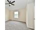 Bright, carpeted bedroom with ceiling fan and a window providing ample natural light at 181 Tracy Ridge Blvd, Whiteland, IN 46184