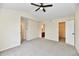 Bedroom with ceiling fan, neutral walls and carpet, and access to a bathroom at 181 Tracy Ridge Blvd, Whiteland, IN 46184