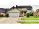 Two-story home featuring manicured lawn, mature trees, and attached garage at 181 Tracy Ridge Blvd, Whiteland, IN 46184