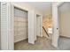 Bright hallway with an open closet, carpet, and access to the staircase at 181 Tracy Ridge Blvd, Whiteland, IN 46184