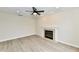 Bright living room featuring hardwood floors, a cozy fireplace, and a modern ceiling fan at 181 Tracy Ridge Blvd, Whiteland, IN 46184