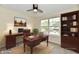Home office features desk, chair, built-in shelving, computer, and natural light at 181 Tracy Ridge Blvd, Whiteland, IN 46184