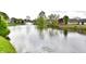 Picturesque pond with a fountain, surrounded by lush greenery and neighborhood homes in a serene setting at 181 Tracy Ridge Blvd, Whiteland, IN 46184