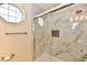 Shower with modern marble tiling, built-in niche, and updated fixtures at 181 Tracy Ridge Blvd, Whiteland, IN 46184