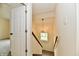 Well-lit staircase with modern lighting fixture and a view of a window at 181 Tracy Ridge Blvd, Whiteland, IN 46184