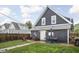 Charming backyard oasis featuring patio furniture, fire pit, and well-maintained lawn at 1852 Singleton St, Indianapolis, IN 46203