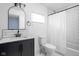 Updated bathroom featuring a dark vanity, black fixtures, and subway tile at 1852 Singleton St, Indianapolis, IN 46203