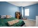 Blue bedroom featuring a work station, bean bag chair, and plush green bedding at 1852 Singleton St, Indianapolis, IN 46203