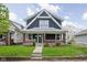 Charming two-story home with a classic front porch and lush green lawn at 1852 Singleton St, Indianapolis, IN 46203