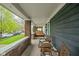A cozy front porch features brick columns and outdoor seating at 1852 Singleton St, Indianapolis, IN 46203