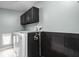 Well-equipped laundry room with modern washer, dryer, and storage cabinets at 1852 Singleton St, Indianapolis, IN 46203