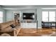 Inviting living room with brown sofa, custom cabinets, and a sleek black foosball table at 1852 Singleton St, Indianapolis, IN 46203
