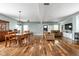 Spacious living room featuring hardwood floors, tan sofas, and a dining area at 1852 Singleton St, Indianapolis, IN 46203