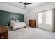 Spacious bedroom boasts abundant natural light, ceiling fan, and sophisticated accent wall at 1852 Singleton St, Indianapolis, IN 46203