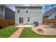Charming backyard with a patio, string lights, and a fire pit seating area at 1909 Orange St, Indianapolis, IN 46203