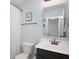 Cozy bathroom featuring a modern sink and mirror, with a toilet and shower at 1909 Orange St, Indianapolis, IN 46203