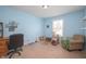 Comfortable blue bedroom with a desk, chair, shelving, and a cat tree at 1909 Orange St, Indianapolis, IN 46203