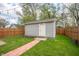 Backyard shed with a brick path and a fenced yard providing a secluded outdoor space at 1909 Orange St, Indianapolis, IN 46203