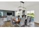 Bright dining area featuring a modern chandelier and stylish gray upholstered chairs at 2242 Hemlock Cir, Greenfield, IN 46140