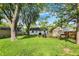 Expansive backyard showcasing a large grassy area, trees, and a shed, ideal for recreation and storage at 2307 Magnolia Pl, Indianapolis, IN 46219