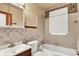 Compact bathroom featuring tile walls, a vanity, and a bathtub with a shower for a practical layout at 2307 Magnolia Pl, Indianapolis, IN 46219