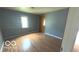 Bright bedroom featuring hardwood floors, a window, and neutral wall paint at 2414 S Rybolt Ave, Indianapolis, IN 46241