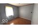 Bedroom featuring hardwood floors, light gray walls, and a window at 2414 S Rybolt Ave, Indianapolis, IN 46241